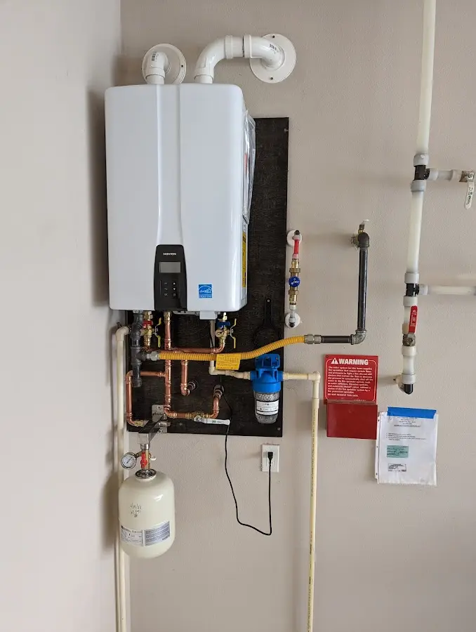 Professional plumber installing copper piping in a Holly Ridge home